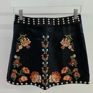 Studded leather mini skirt